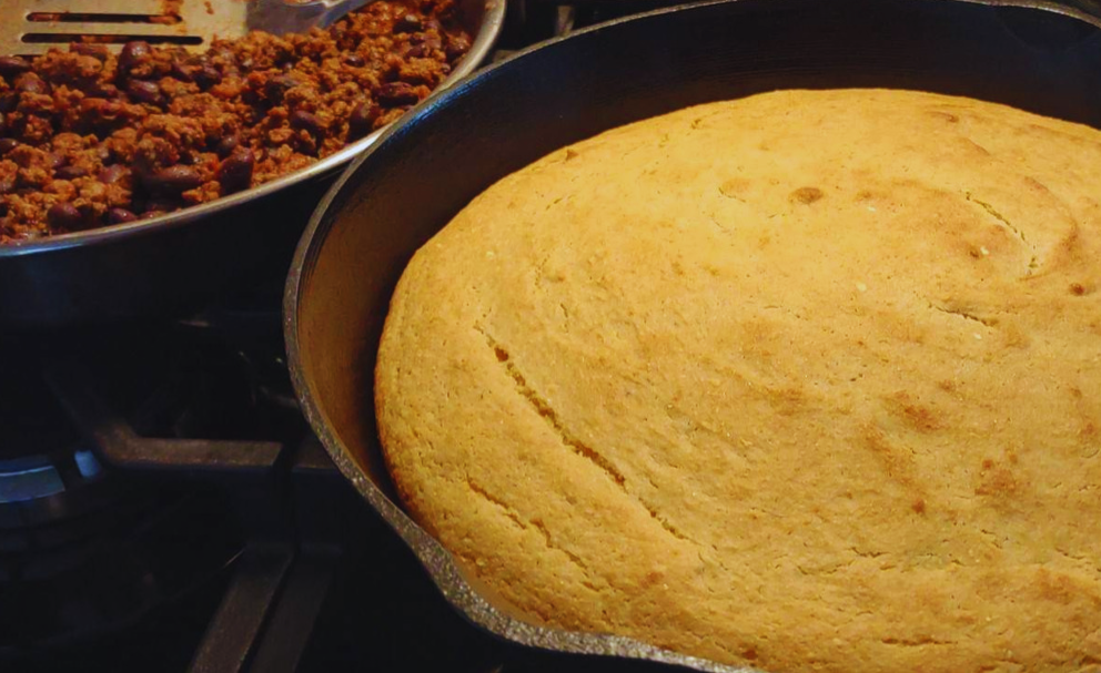 baked sweet cornbread in a cast iron skillet made with fresh milled corn and flour