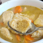 egg drop dumpling on a spoon above turkey soup