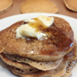 sourdough pancakes made with fresh milled flour with butter and maple syrup on top