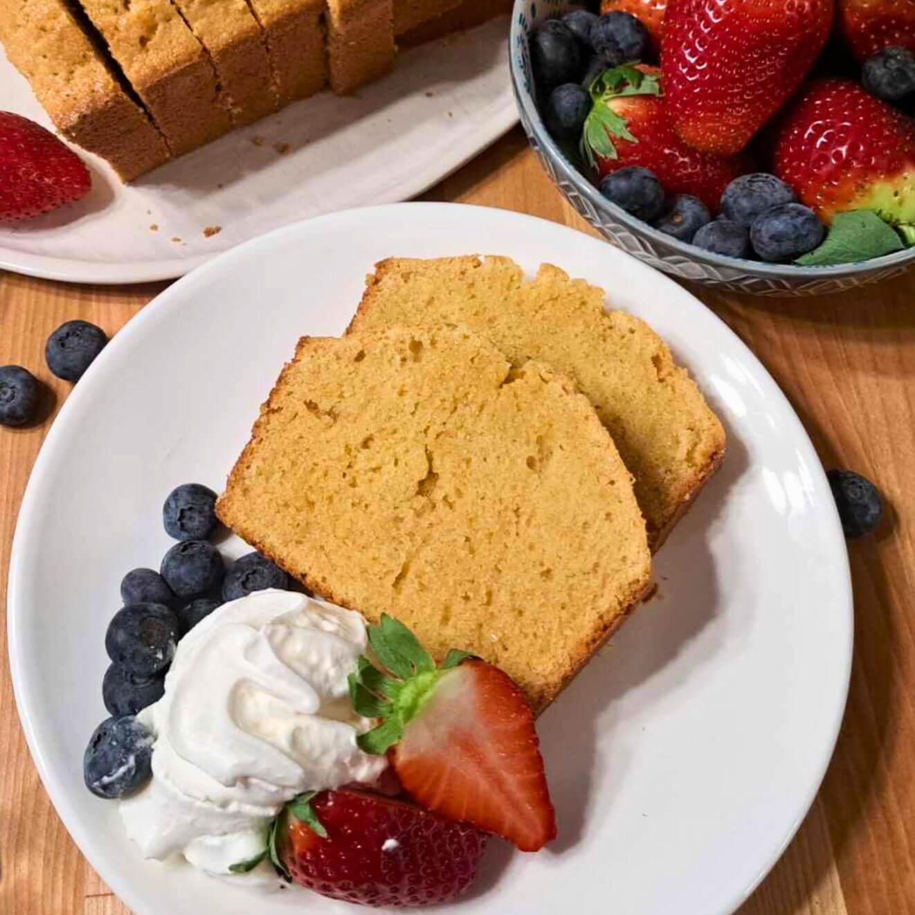 fresh milled flour pound cake with whipped cream and berries