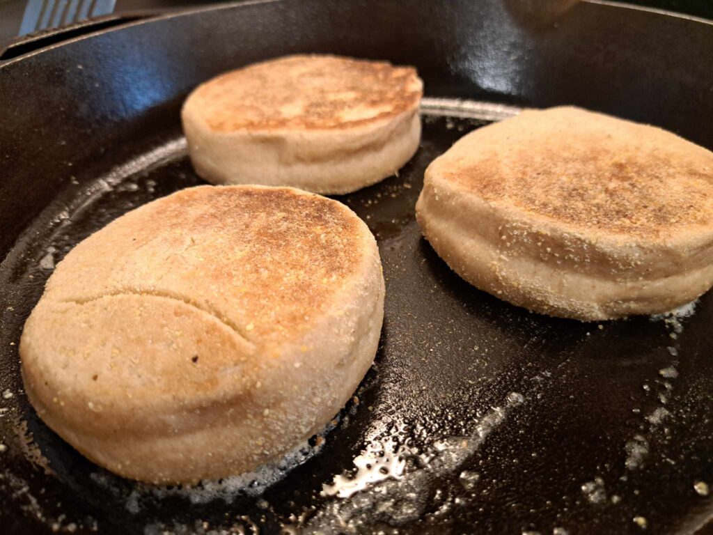 English muffins frying in skillet