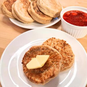 fresh milled flour homemade English muffins on plate with butter and jelly