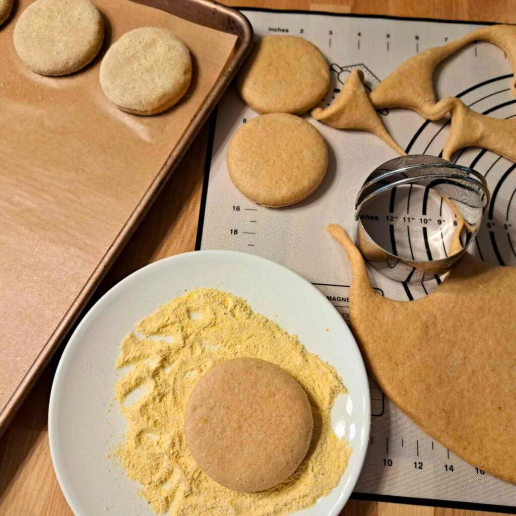 cutting English muffins and dusting with cornmeal