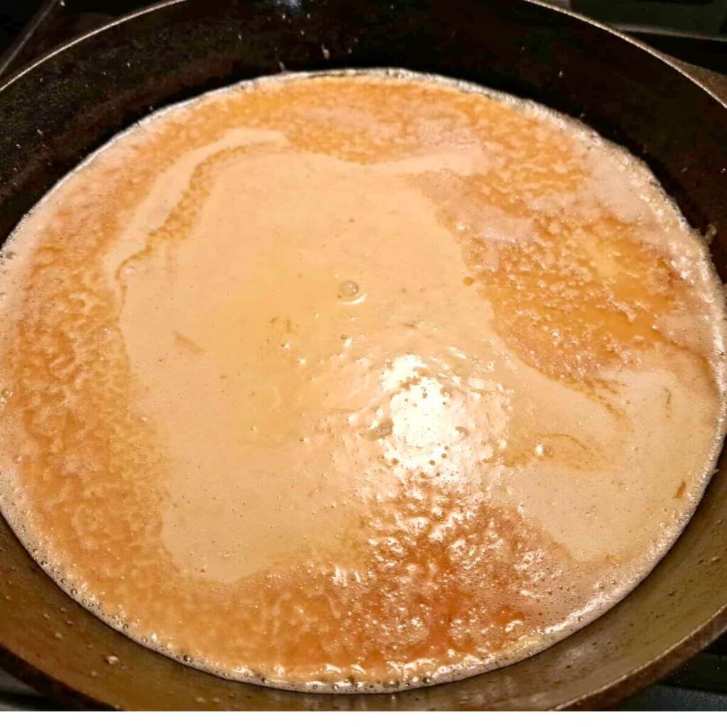 dutch baby made with fresh milled flour batter in hot skillet ready to go in the oven