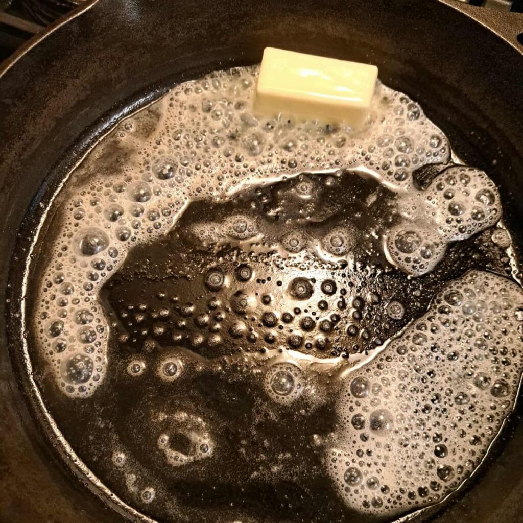 melting butter in a preheated cast iron skillet