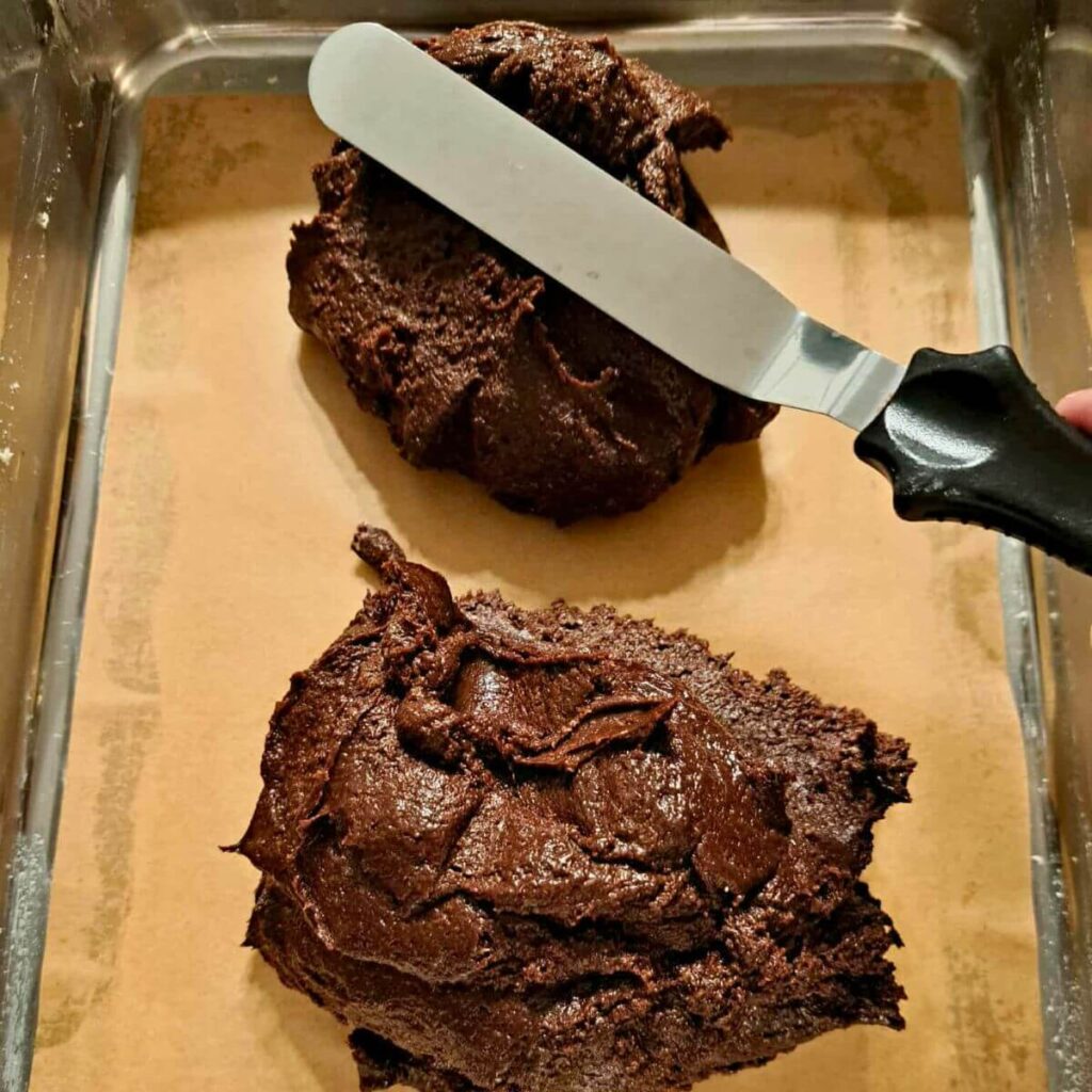 spreading brownie batter with angled spatula