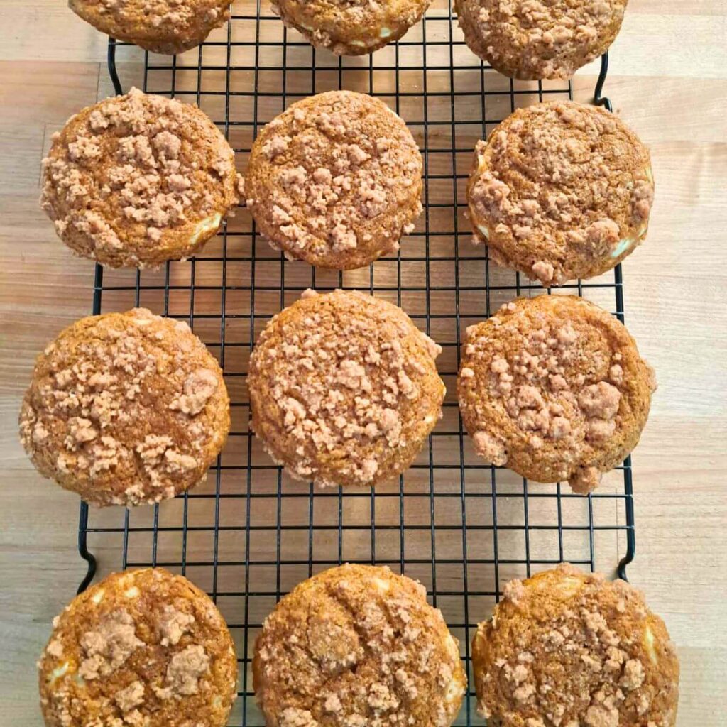 pumpkin cheesecake muffins made with fresh milled flour on a cooling rack