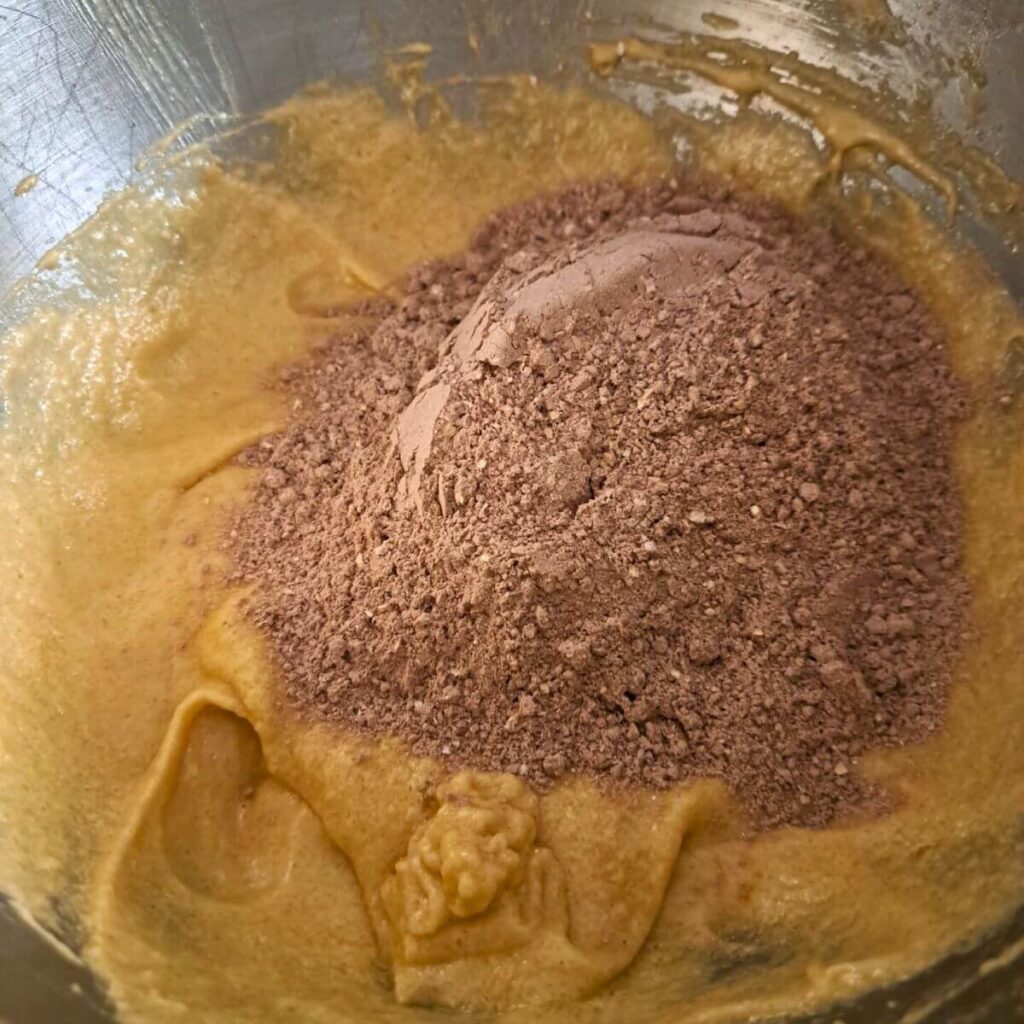 adding dry mix to creamed butter and egg mixture